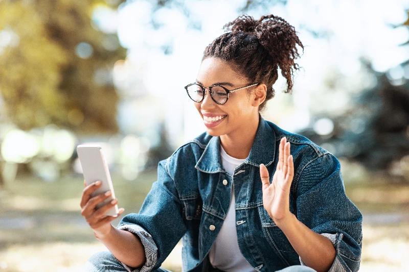 Happy woman using smartphone to make a call