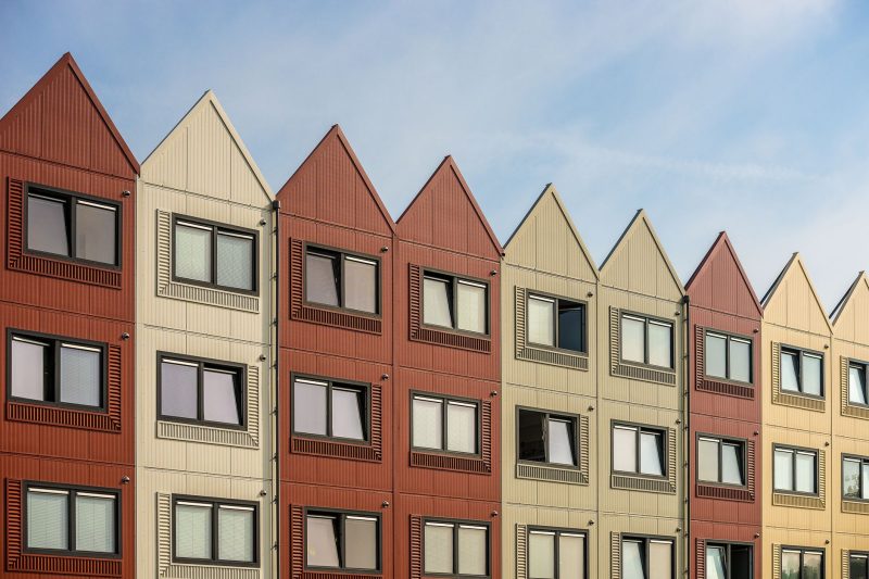 Home 13 A vibrant row of gableroofed residential buildings with meta 1782838821